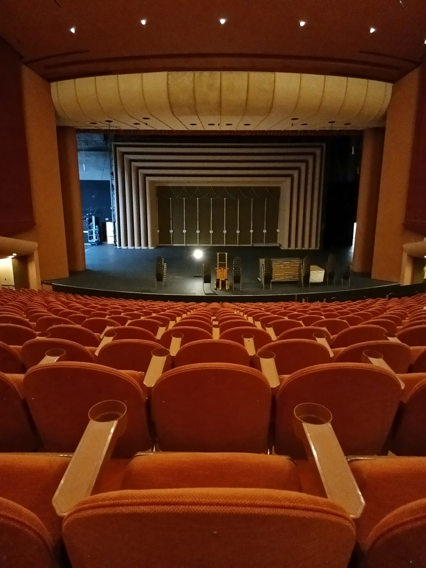 A theater with rows of seats and a stage.