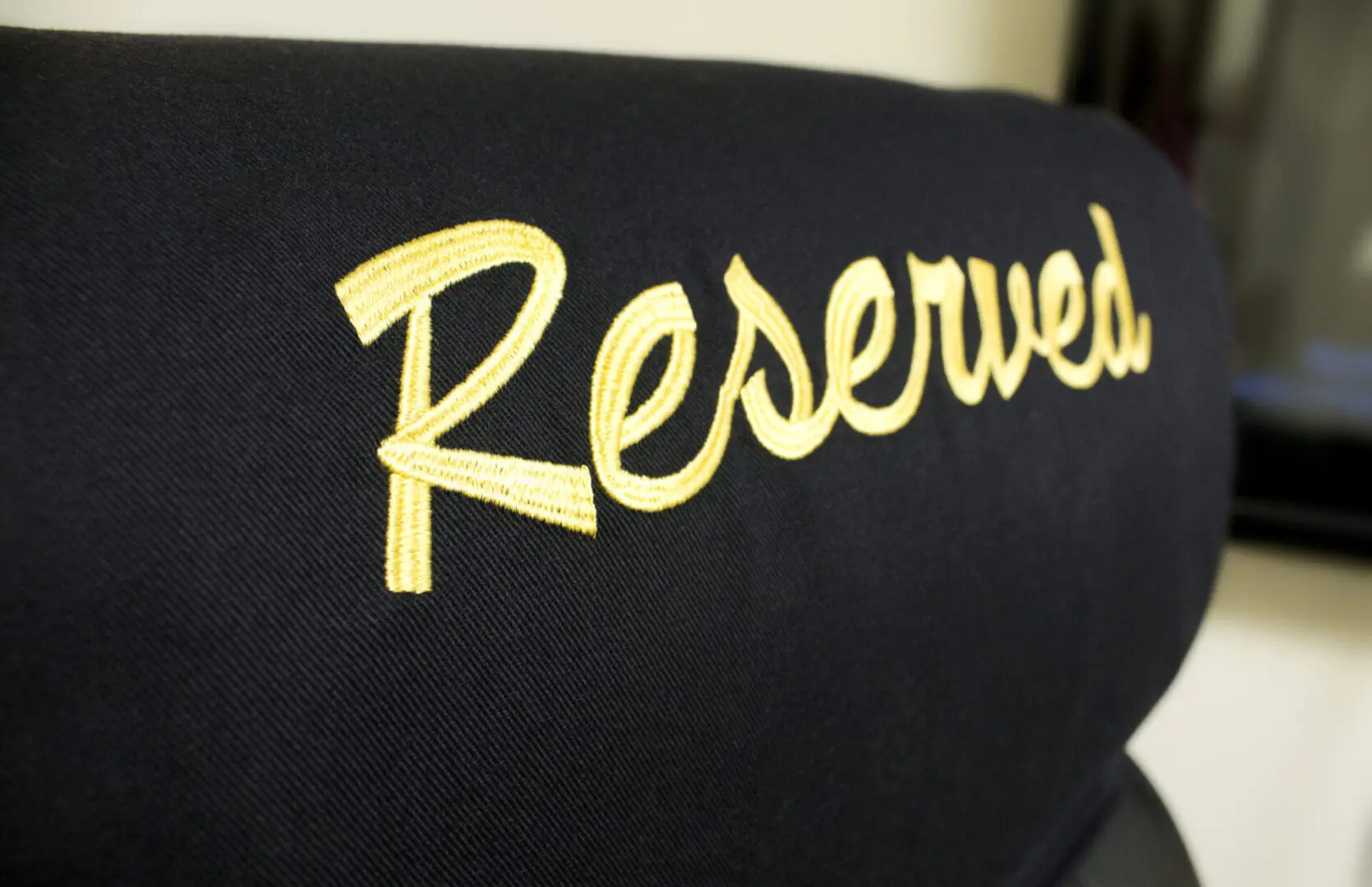 A close up of the word reserved on a chair